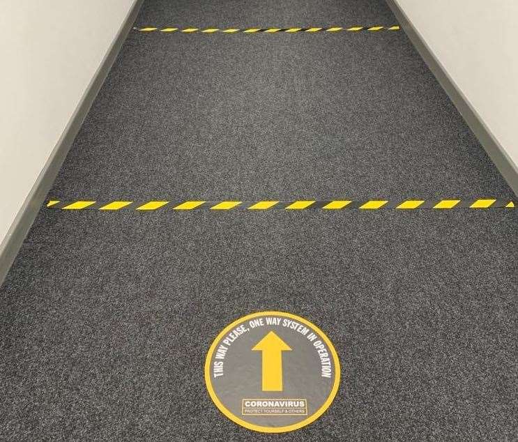 The floor markings encourage people to keep a two-metre distance