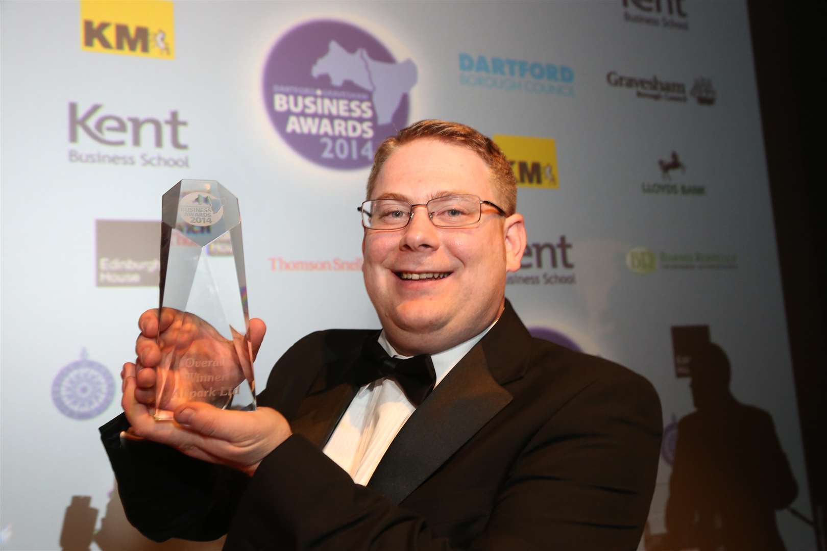 Adam Barlow lifts the winners' trophy for Allpark at last year's Dartford and Gravesham Business Awards