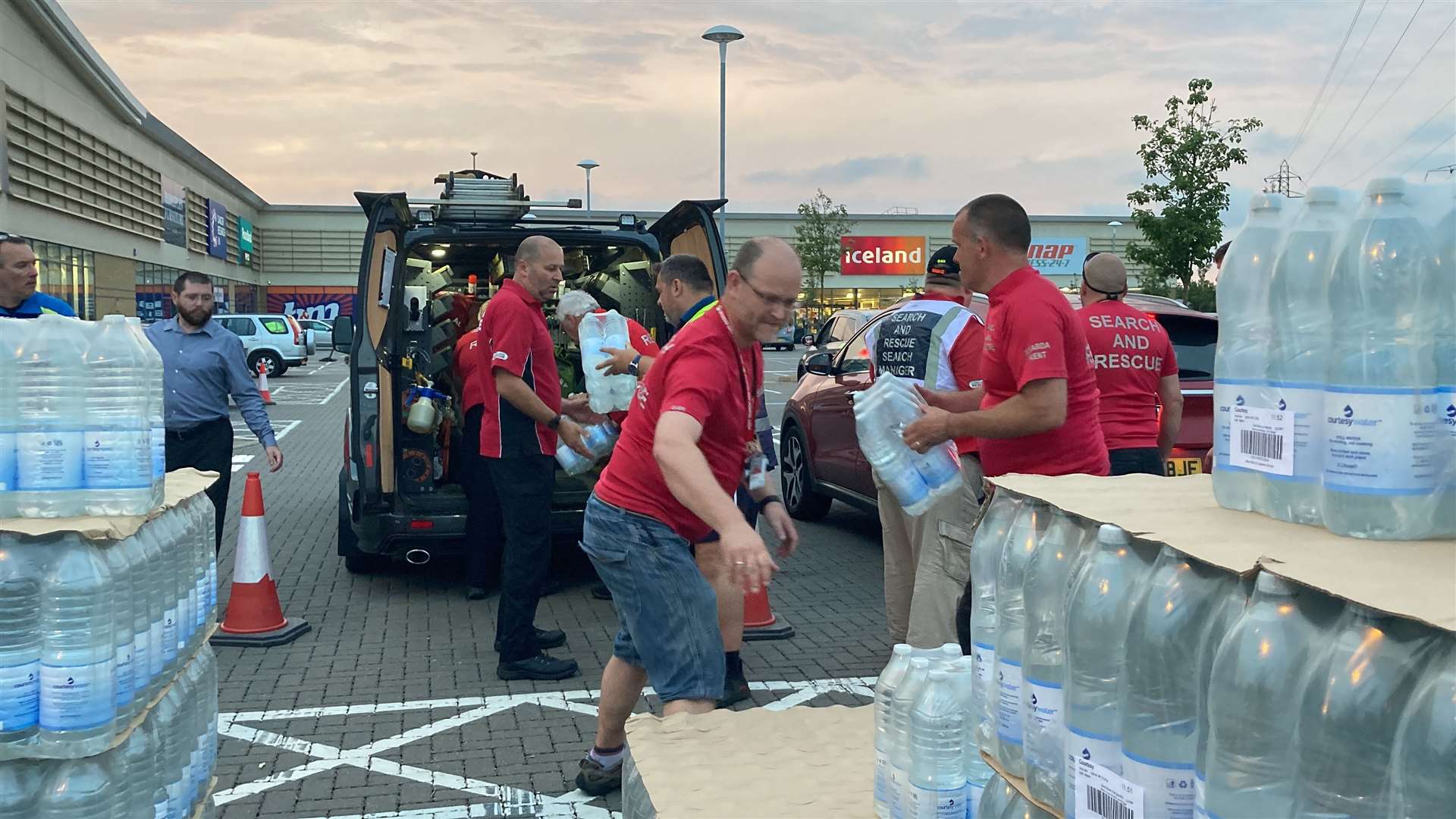 Kent Search and Rescue volunteers distributing bottles of water at Neats Court retail park
