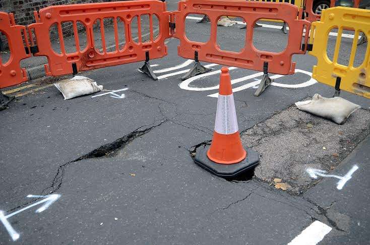 The sink hole has been partially covered by a cone. Picture: Chris Davey