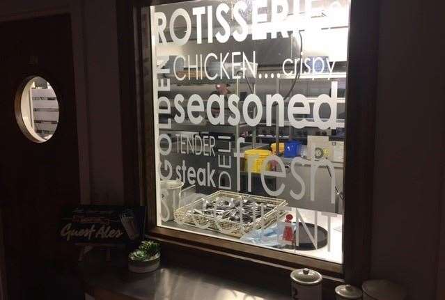This etched glass window allows a glimpse into the action in the kitchen