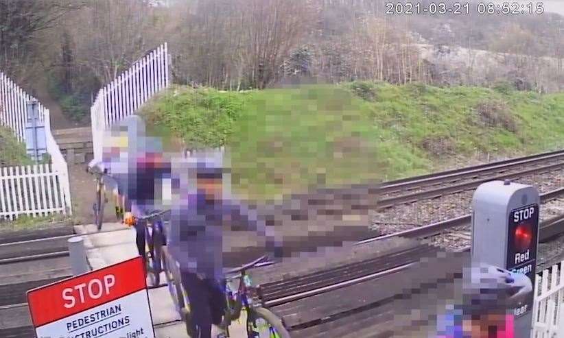 The moment a train narrowly misses four reckless cyclists crossing on a red light at the Pebble Street level crossing near Rochester. Picture: Network Rail