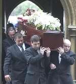 The coffin leaves the chapel