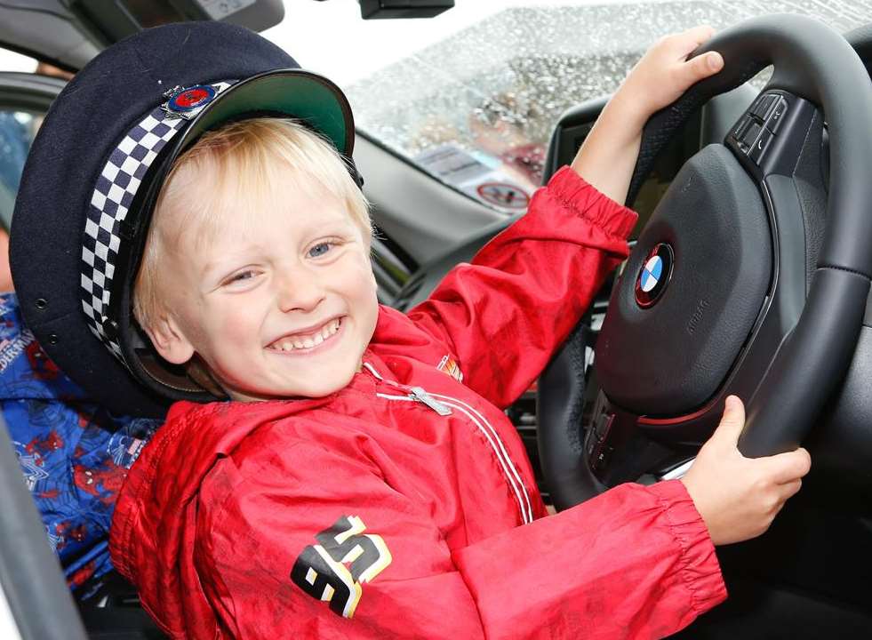 Aston Brooks, 4, in a police car