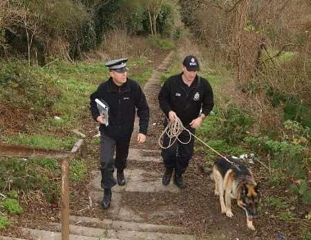 Police officers using a tracker dog in the search for Terry at the weekend at Coney Bank at Chatham. Picture: BARRY CRAYFORD