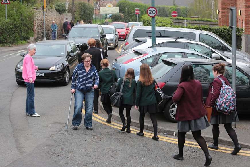 Sue Robertson escorts children after drivers blocked the footpath
