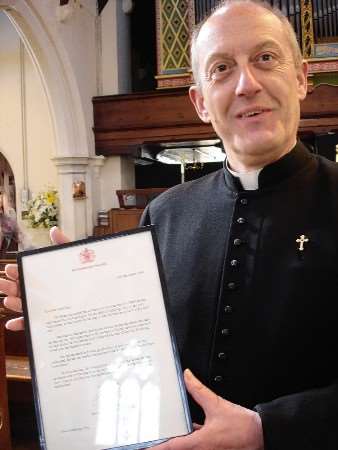 Father Christopher Lindlar with the Queen's letter