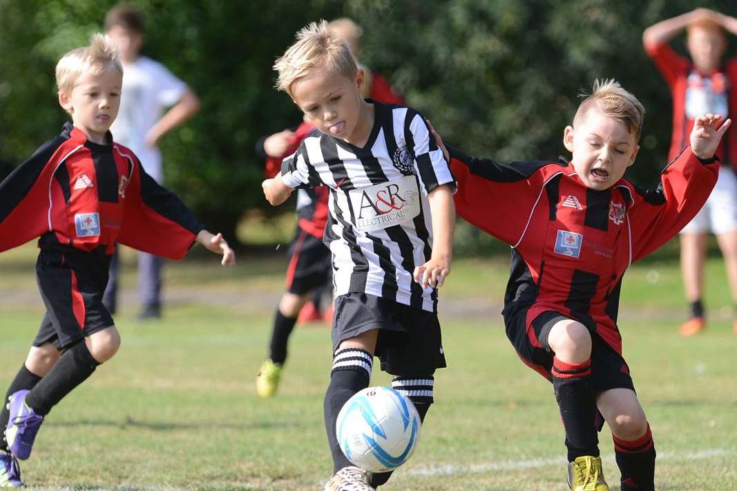 Under-7s Woodcoombe Youth (red/black) and Real 60 do battle Picture: Gary Browne