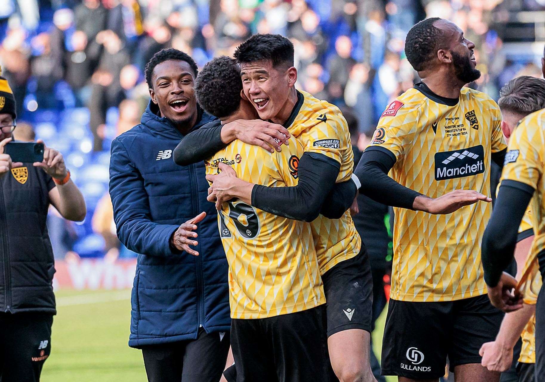 Bivesh Gurung embraces Liam Sole after Maidstone's FA Cup win at Ipswich. Picture: Helen Cooper
