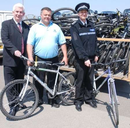 Mick Cronin, Kevin Sherman and Ch Insp Tony Kofkin with some of the bikes bound for Africa.