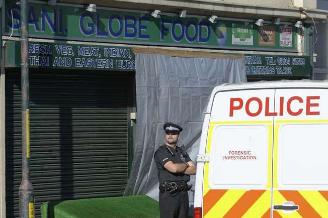 Police outside the Luton shop where Harjit Chaggar's body was found