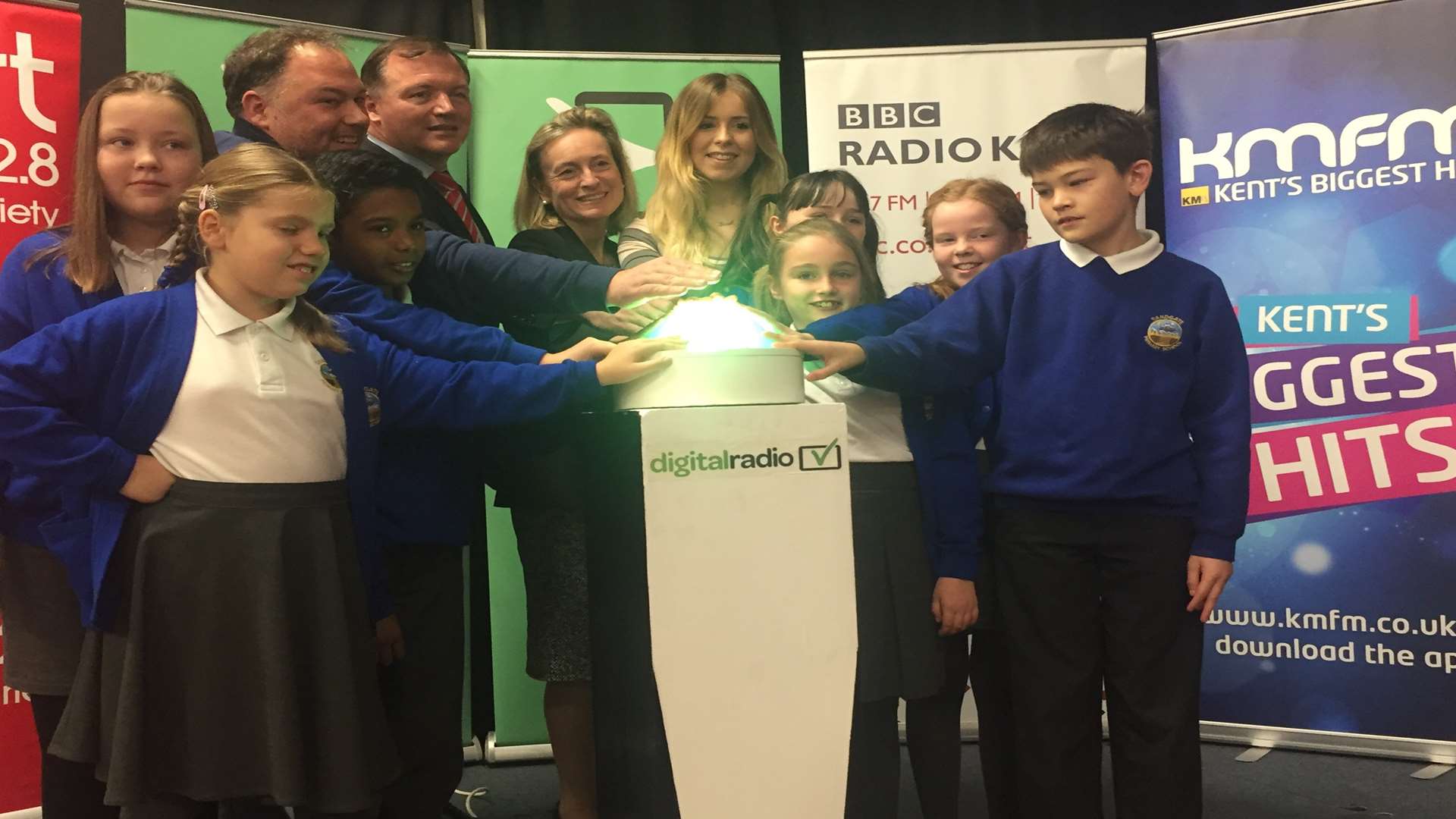 Pupils are joined by kmfm presenters Garry and Laura, KM Group chairman Geraldine Allinson and MP Damian Collins for the big switch-on.