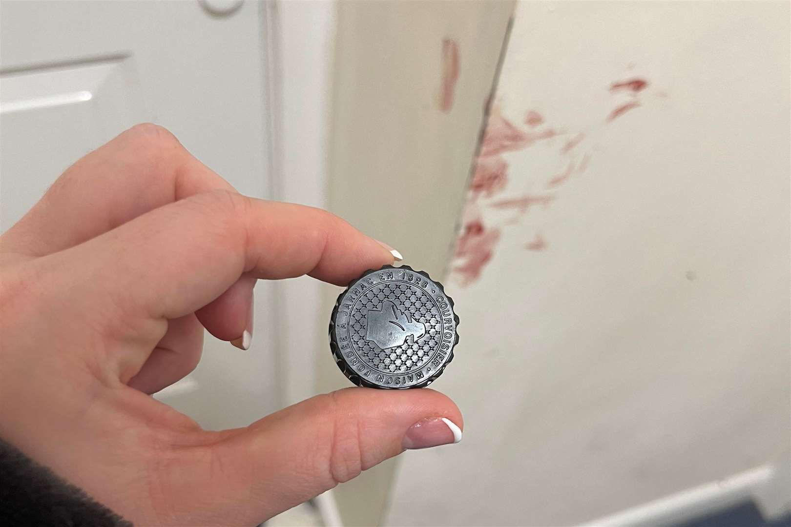 A lid from a bottle of alcohol left by the man who attempted to get into Rachael's flat