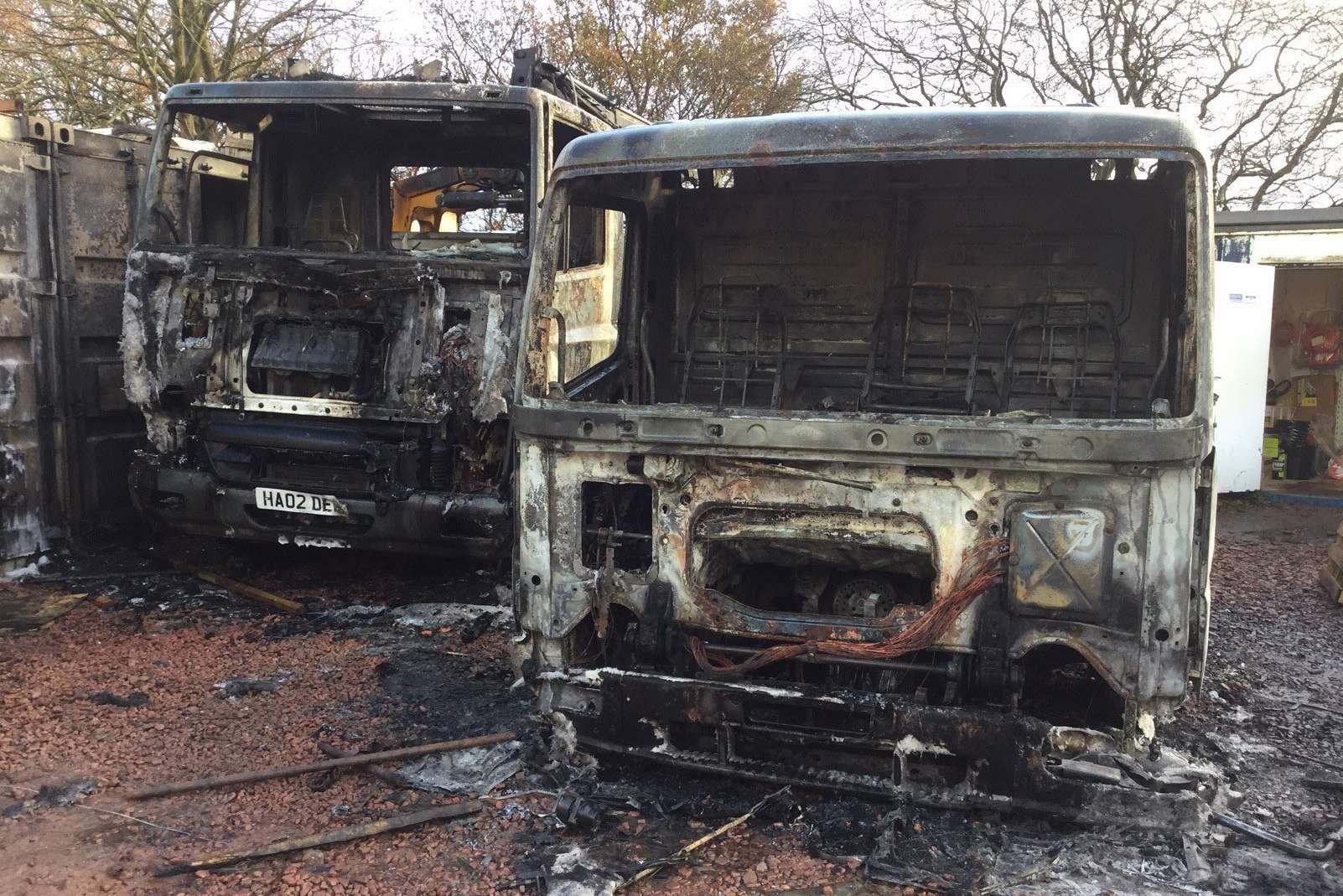 The remains of the lorries destroyed by arsonists