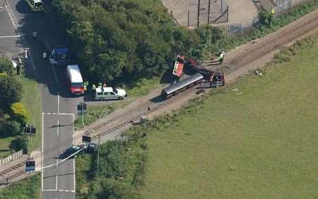 The scene of the crash with the train in the centre and the crushed car bottom left. Picture: SIMON BURCHETT