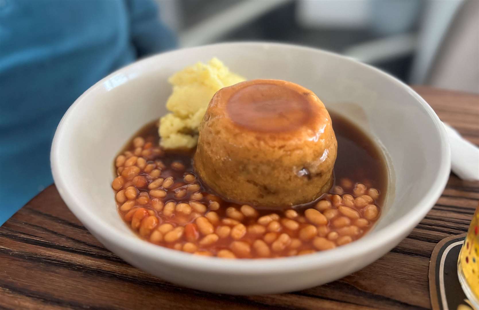 The steak and kidney suet pudding perched within a sea of baked beans