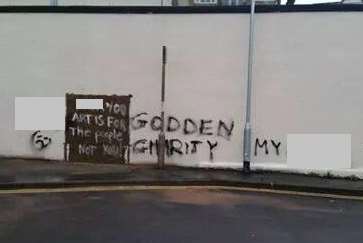 The graffiti was sprayed in the void left by the removal of the Banksy. Picture: Michelle Goody