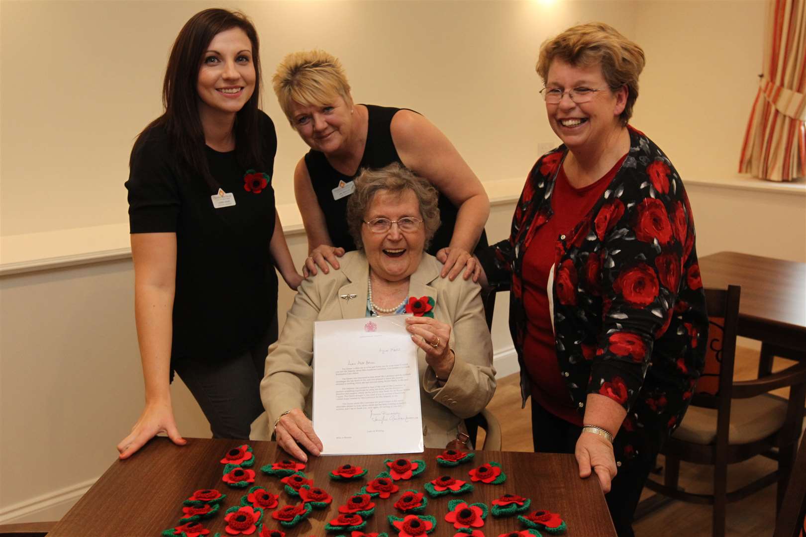 Josie Lawrence and Hillbeck workers Lauren Maher, Jan Molton and Anthea Bowen with the letter from the Queen
