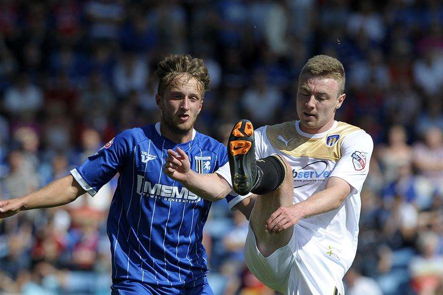 Stephen Butcher (left) in League 1 action for Gillingham against Colchester Picture: Barry Goodwin