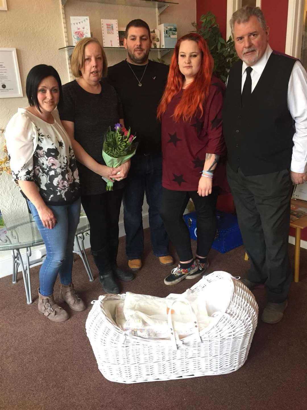 India and Jamie hand over the cuddle cot to Sterry Funeral Service, from left, Amy Walker from Cariad Angel Gowns, fundraising helper Elaine Wilson, Jamie Hayes, India Gibson and Clive Sterry