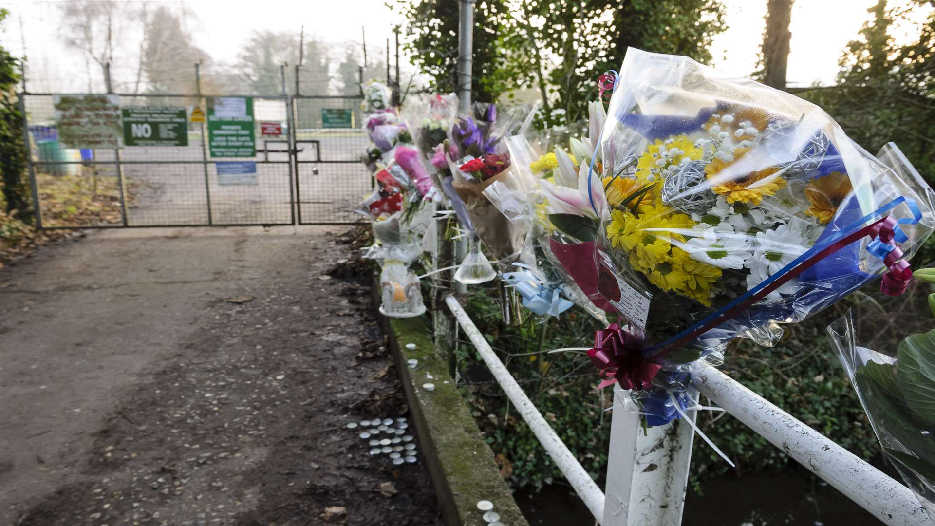 Floral tributes, cards and views of the gates at DDAPS Sutton-At-Hone fishing lakes, where the body of teenager Jack Morrison was found on Saturday.