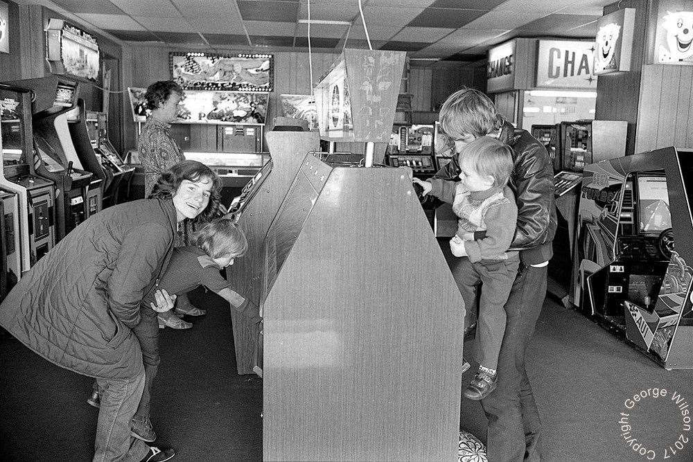 Family fun at the arcades in the 1980s. Copyright: George Wilson