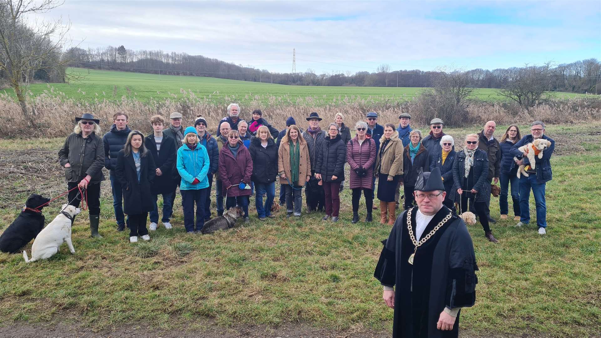Anti-bypass campaigners in Fordwich, Canterbury. The new road would follow the tree line behind them. Picture: KM