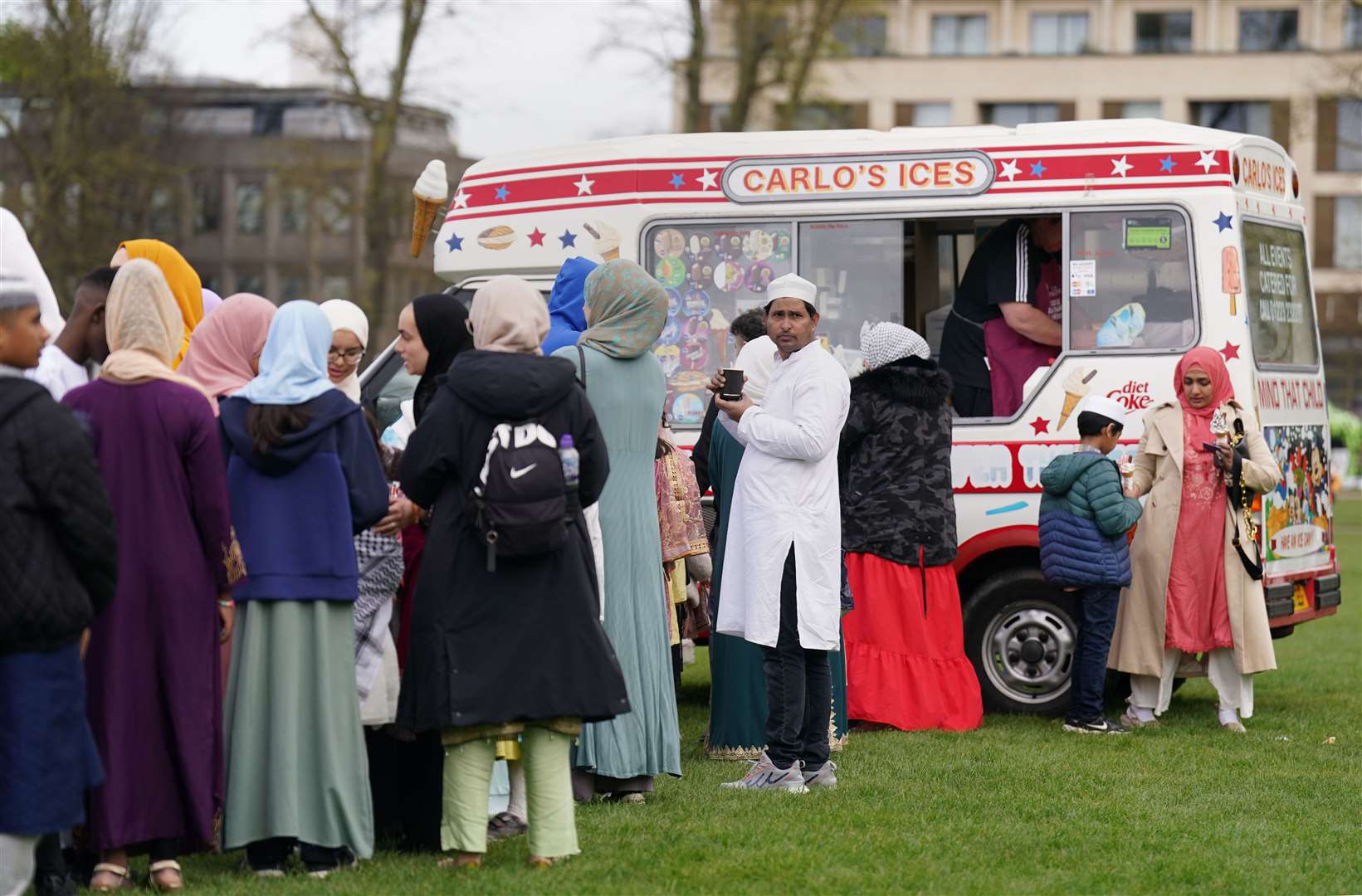 People queued for ice cream in Parker’s Piece, Cambridge (Joe Giddens/PA)