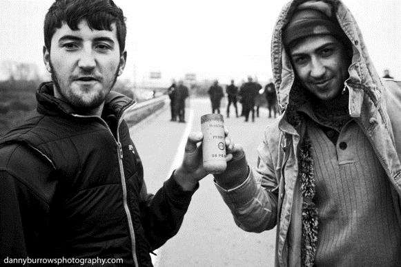 Refugees with an empty can of pepper spray that has been used on the camp by officials. Picture by Danny Burrows