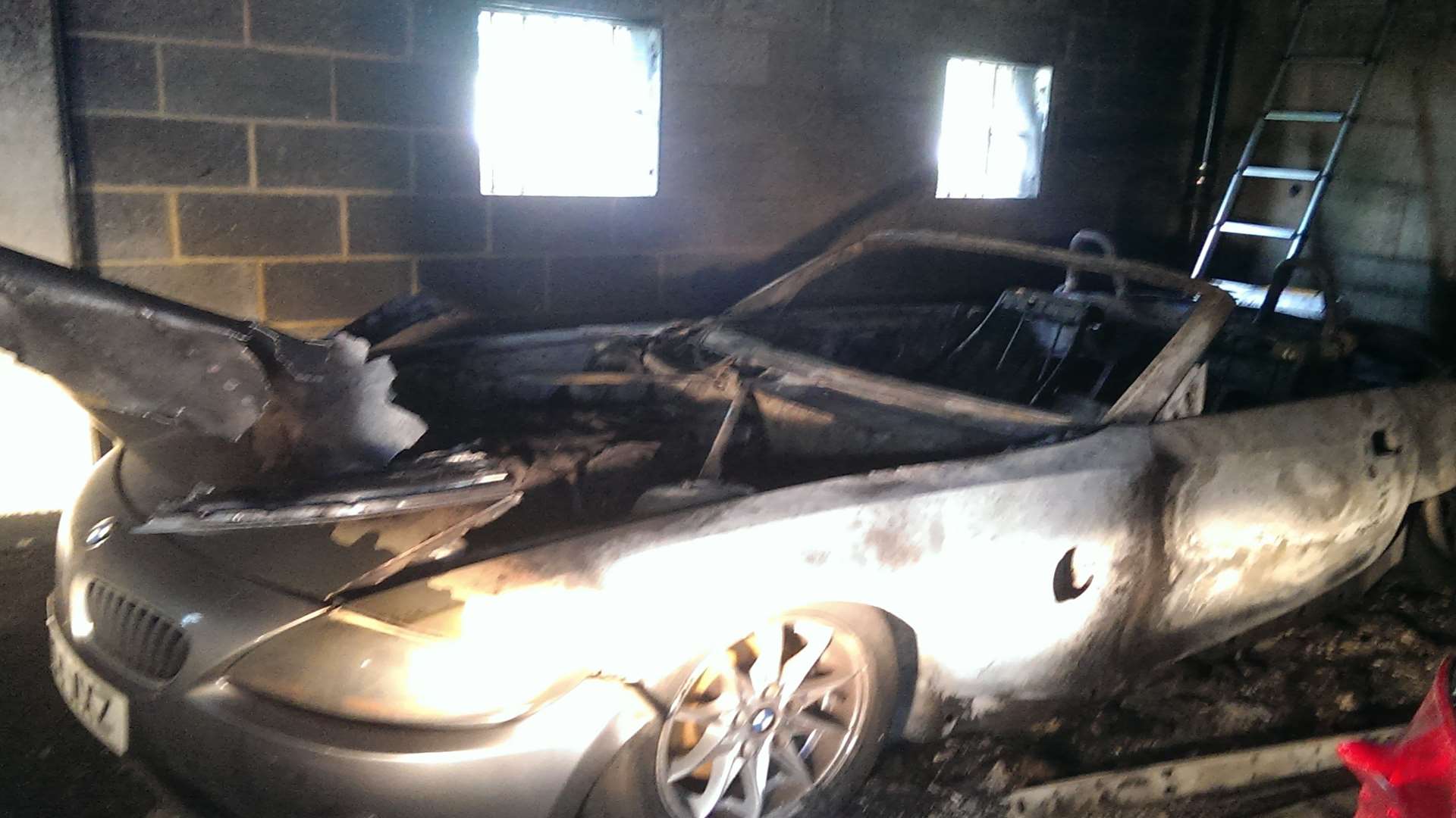 A burnt-out car caused by blaze at Tannery development