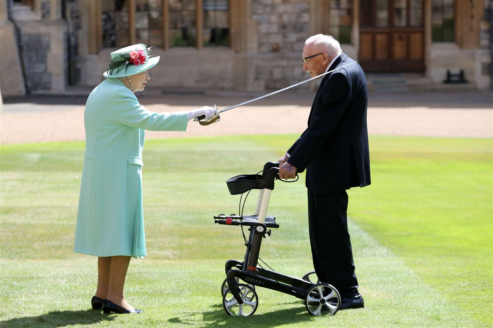 Captain Sir Tom Moore is featured being knighted by the Queen in her Christmas broadcast (Chris Jackson/PA)