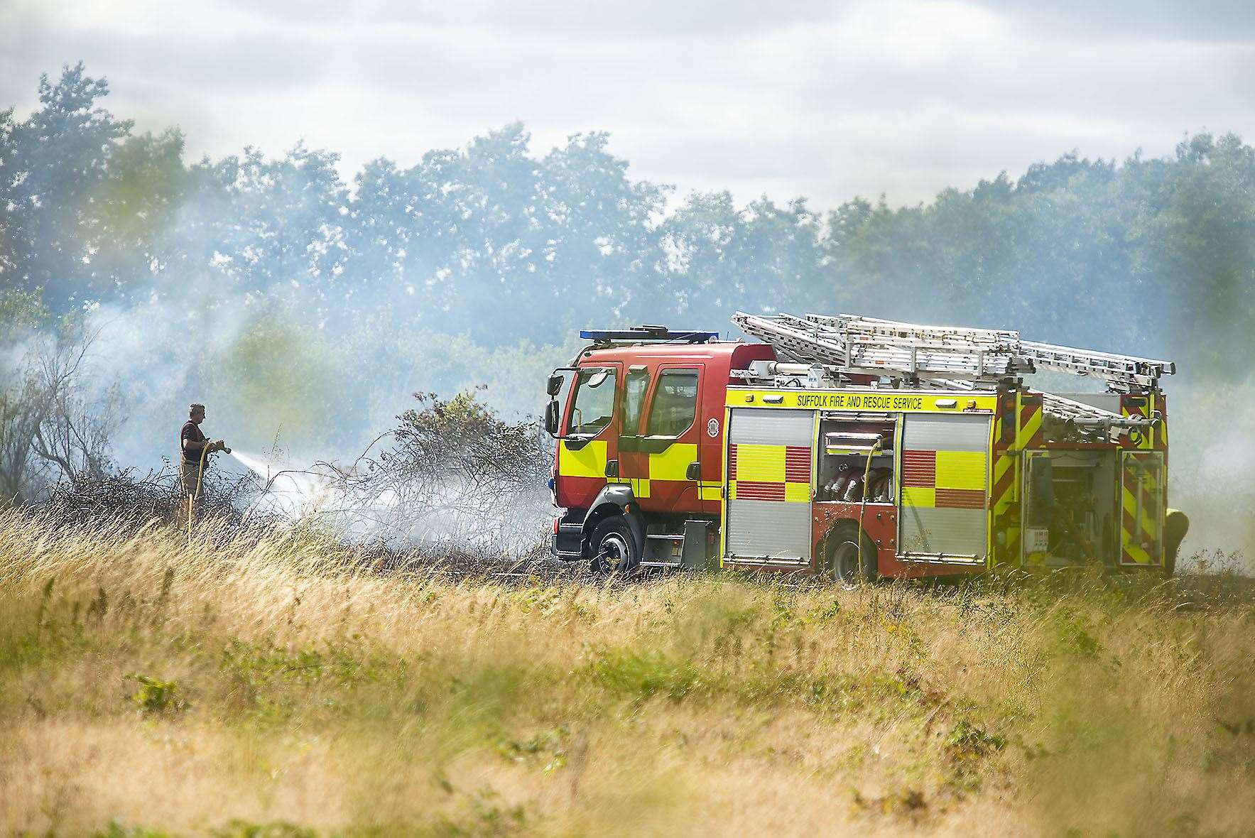 Fire engine fights field blaze. Stock photo: Mark Westley