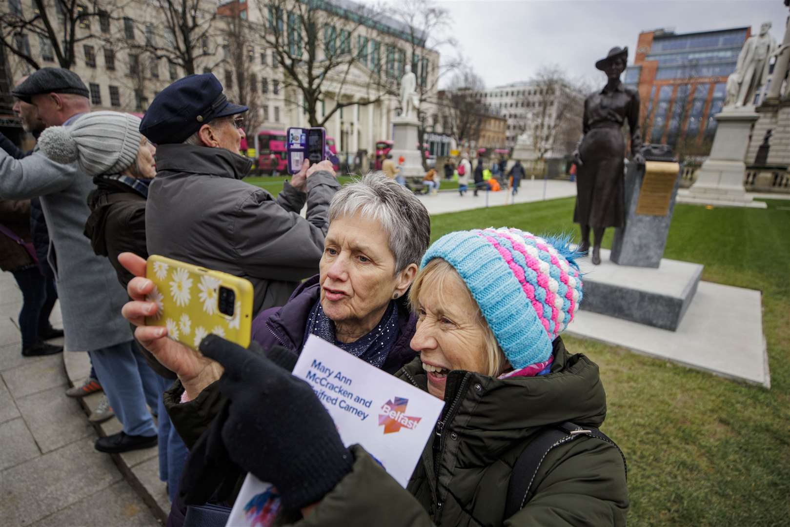Mary Boyd (left) poses with her sister Eileen McKay as she takes a selfie with a newly unveiled statue of Winifred Carney (Liam McBUrney/PA)