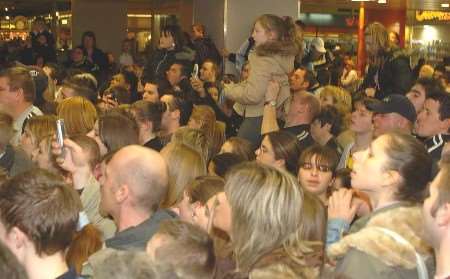 Shoppers gather to get a glimpse of the celebrity couple. Picture: STEVE CRISPE