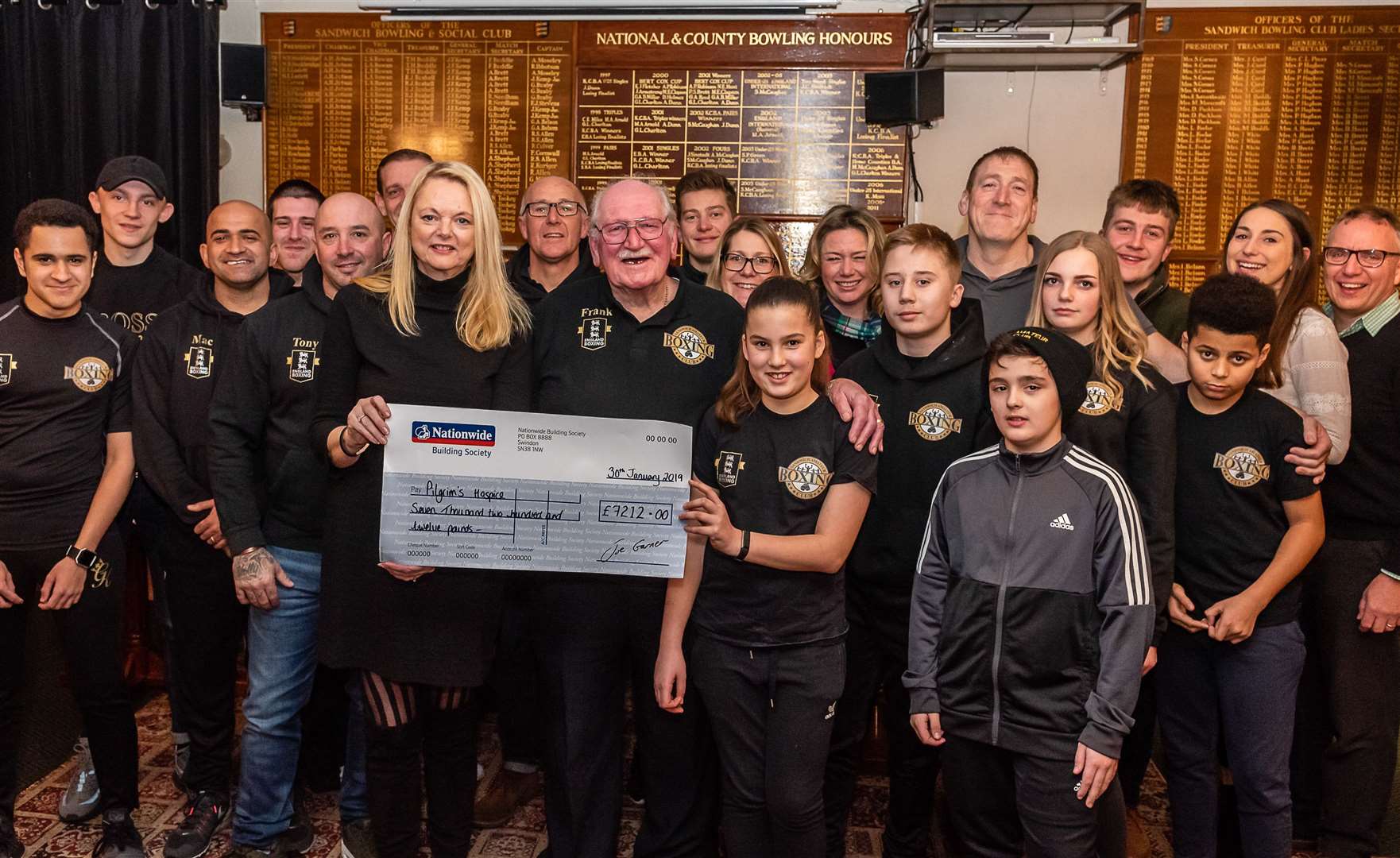 Liam Evans (front right) and his fellow Sandwich Boxing Club members presenting a cheque to Pilgrims Hospice earlier this year