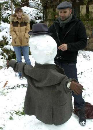 Kelly Brook and Billy Zane enjoy the snow in the garden of their Kent country mansion. Exclusive picture: GRANT FALVEY