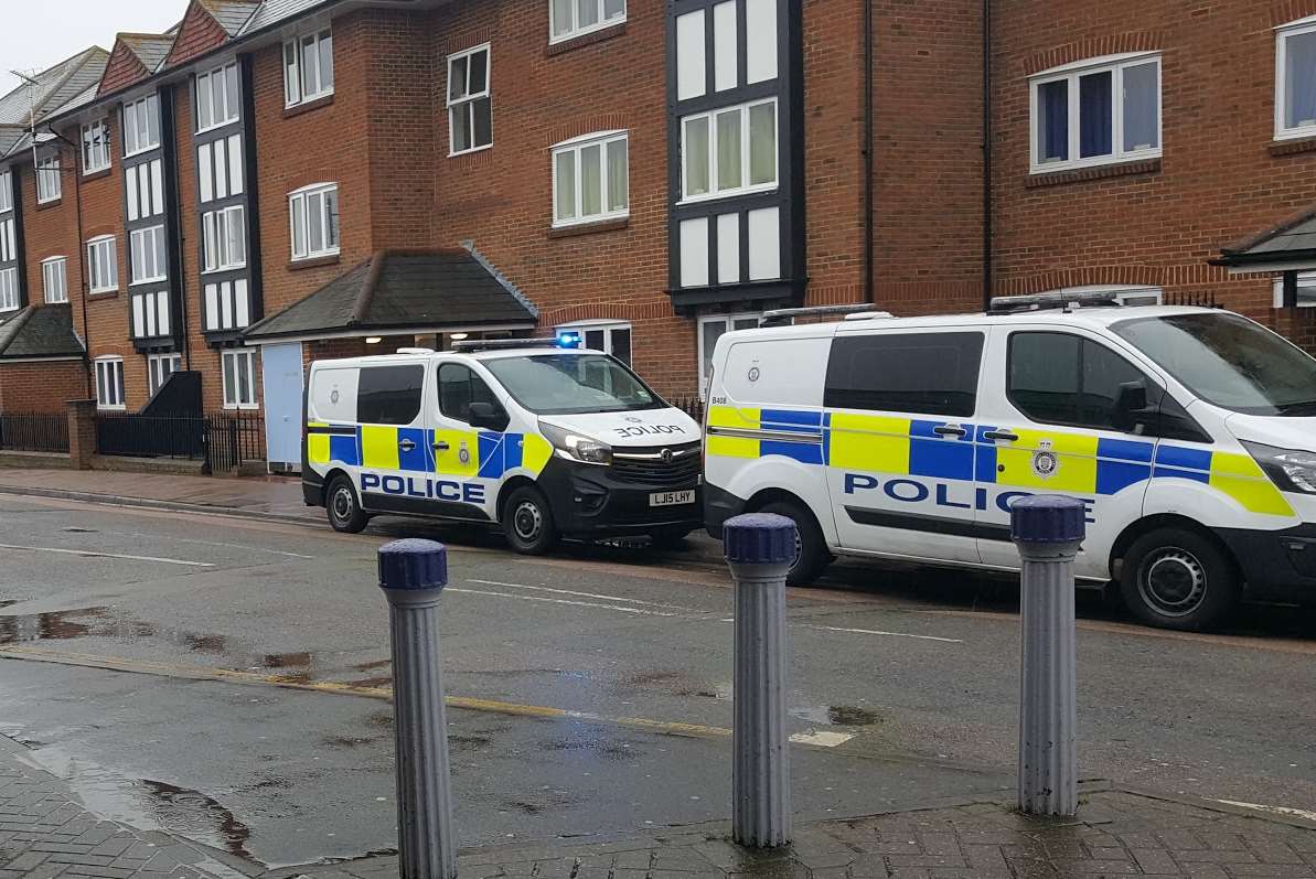 Police vans outside Canterbury East after a person died when they were hit by a train