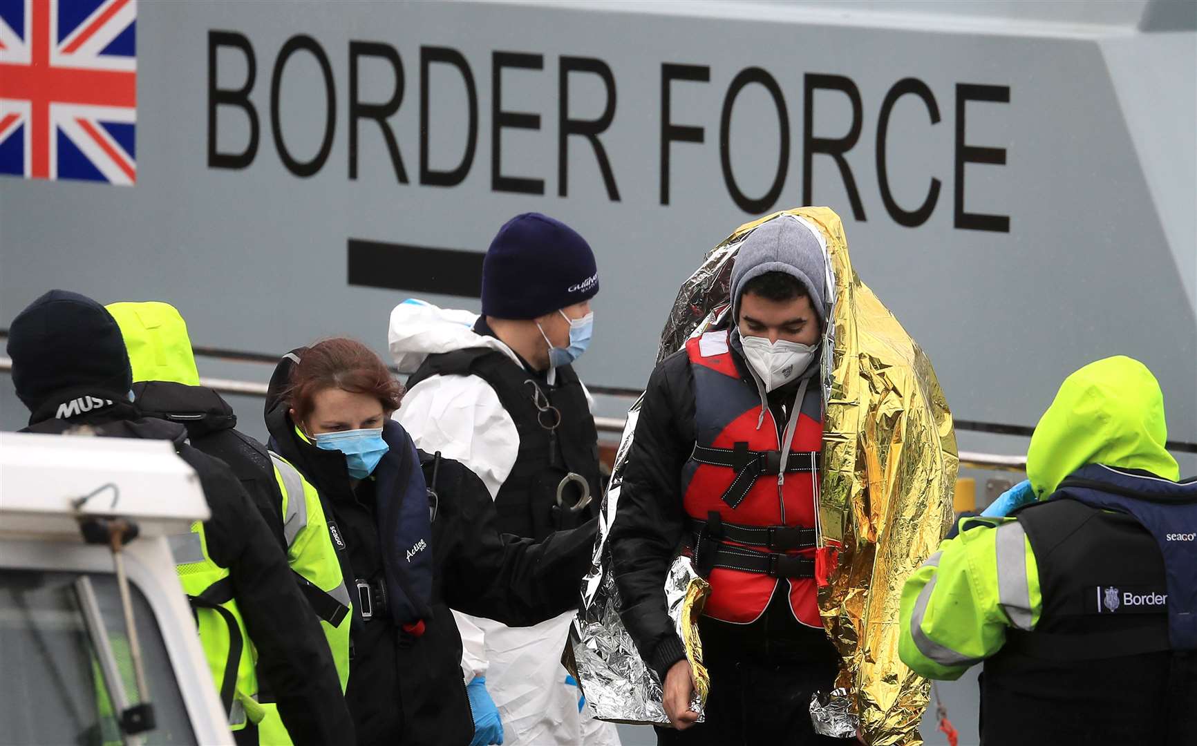 A man is helped by a Border Force officer (Gareth Fuller/PA)