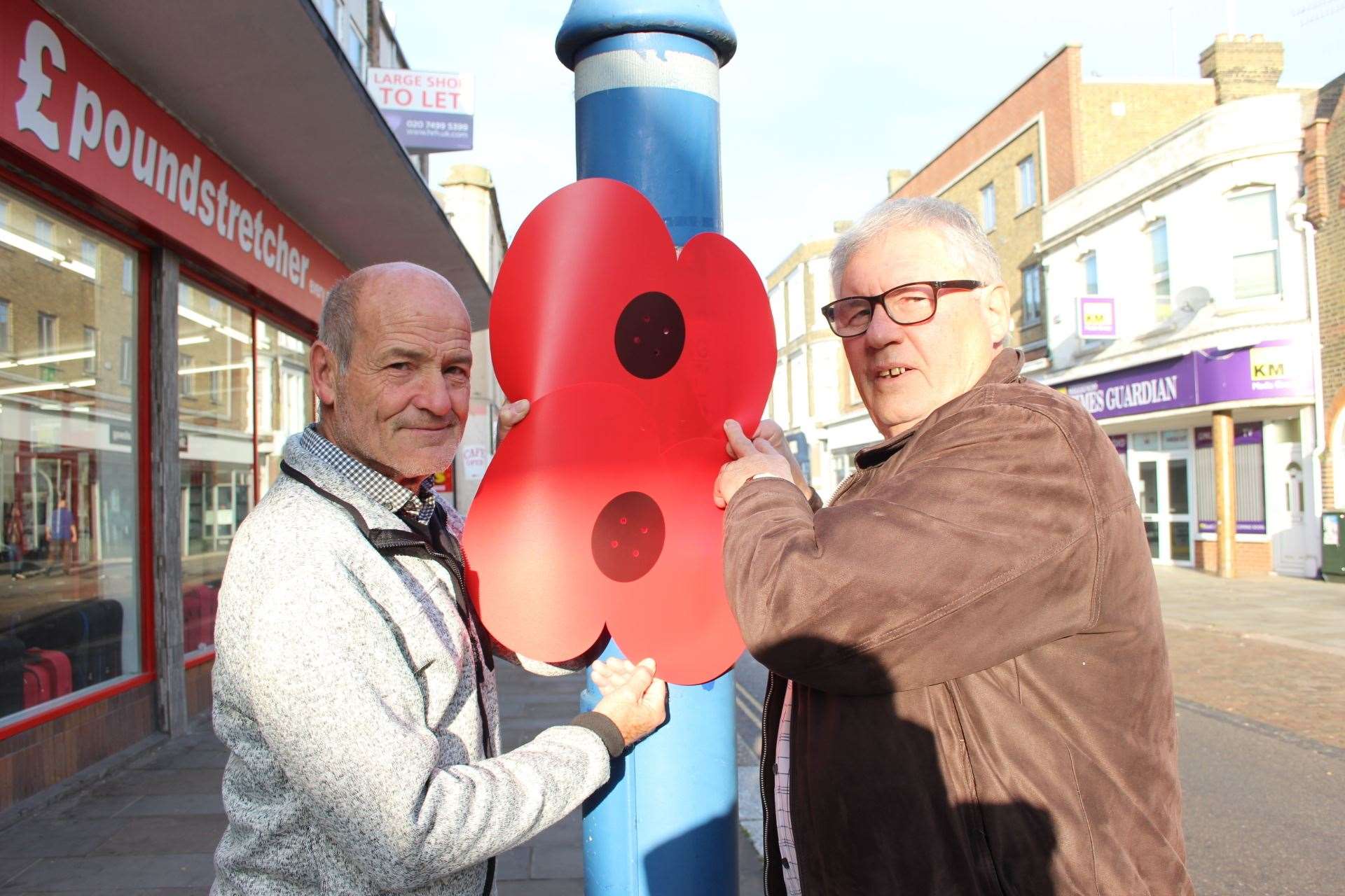 Bob McCall, left, and Brian Spoor of the Sheerness Town Team have attached giant popies to lampposts (21038165)