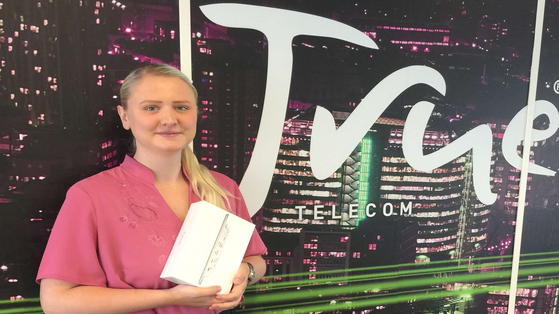 Fern Hugill from True Telecom with the iPad mini 2 that will go to the biggest individual fundraiser at the KM Assault Course Challenge on October 3.