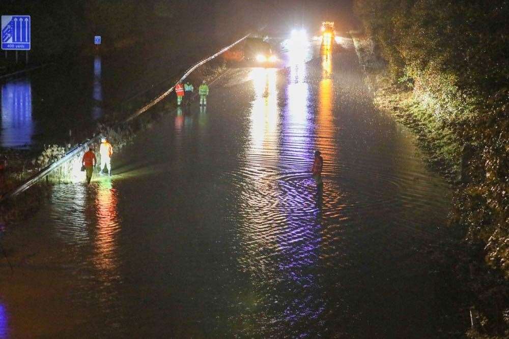 Drivers were stranded after torrential rain flooded the M23 last night. Photo: UKNIP