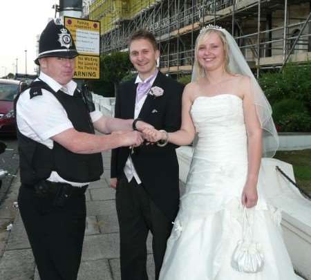PC Darren Parkinson slaps the handcuffs on newly-weds Stuart and Claire Davies