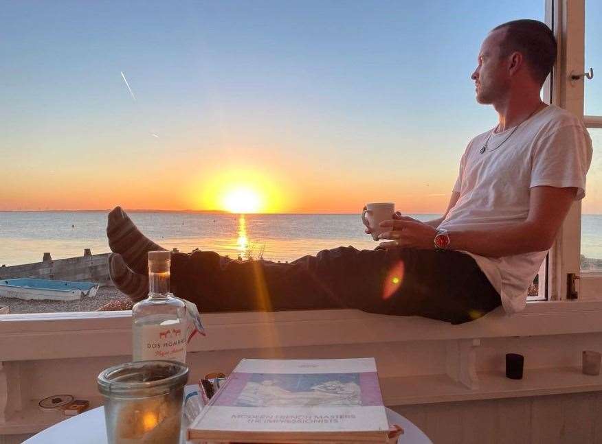 Breaking Bad star Aaron Paul looks out across the Whitstable seafront, with a bottle of his Mexican-style mezcal Dos Hombres on the table beside him. Picture: @laurenpaul8/Instagram