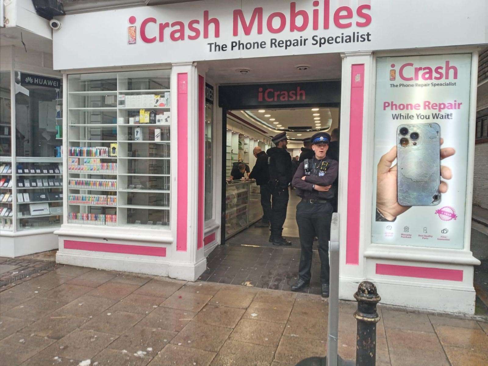 Police at the iCrash Mobiles store yesterday