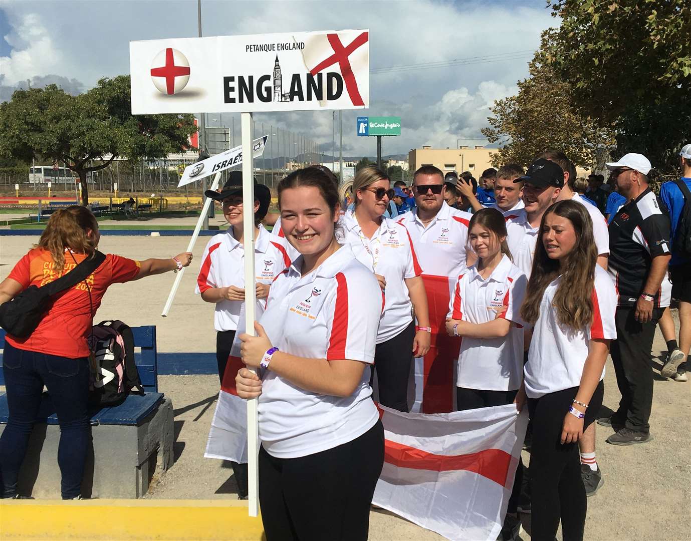 Gravesend's Sophie Rowley holding an England sign aloft as she basks in the sun in Spain