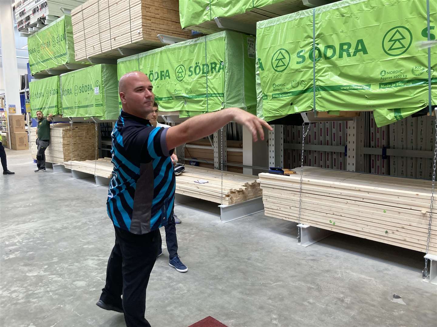 Darts player Rob Cross competes in an unusual setting, inbetween the planks of wood at the Selco Builders merchants Medway City Estate, Strood