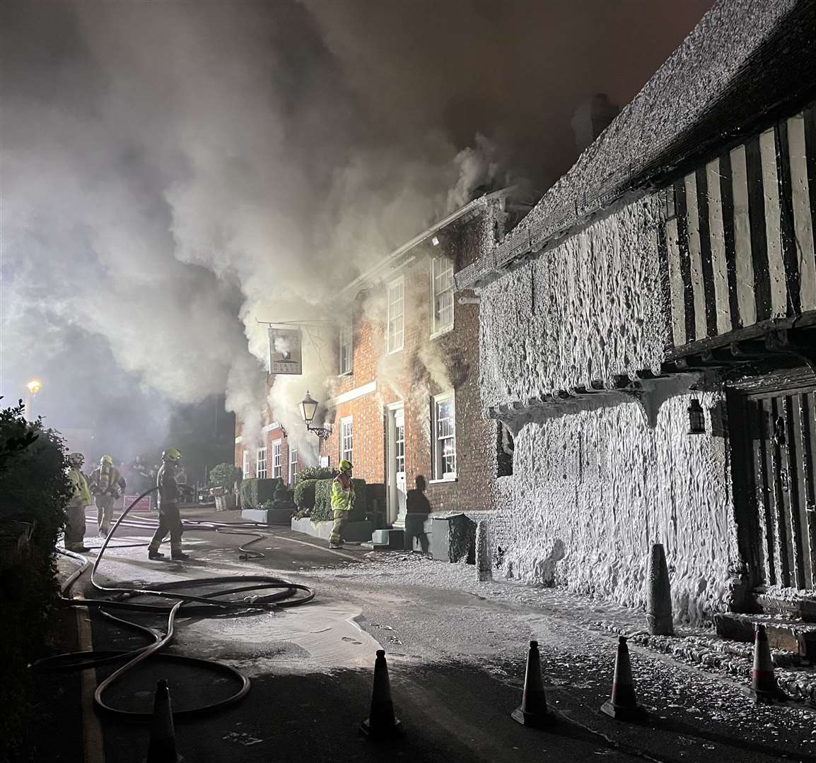 Firefighters doused nearby homes in foam to stop the fire spreading. Picture: John Wills
