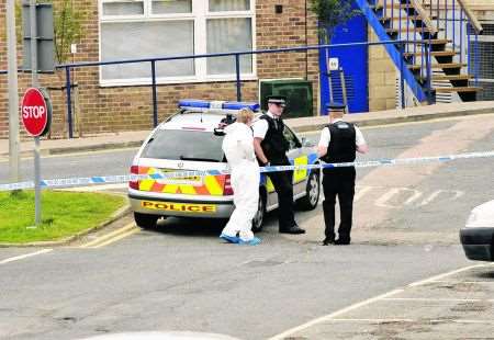 Police forensic officers at the Kent University campus, working on an area of sealed off car park by the Mandela building.