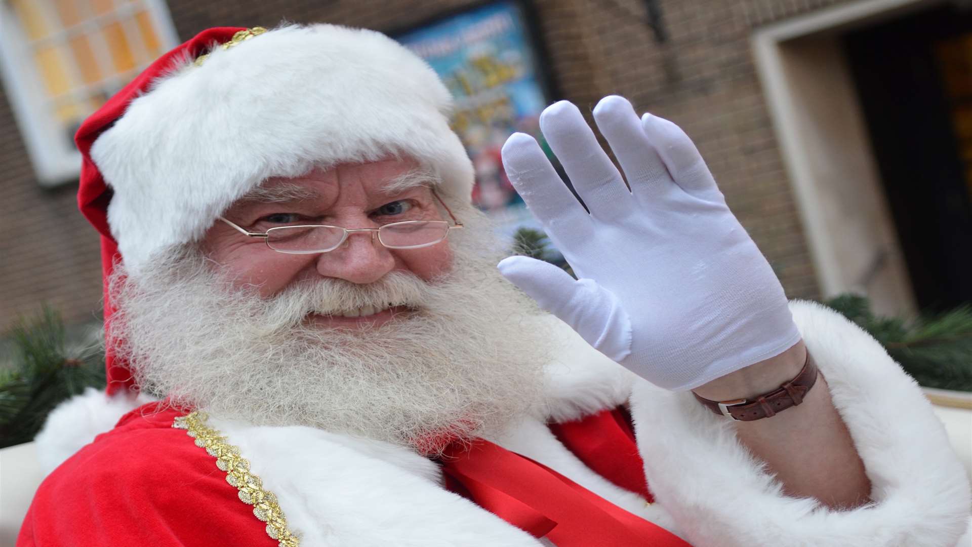 Father Christmas waves to the crowds as he makes his way to the Royal Victoria Place