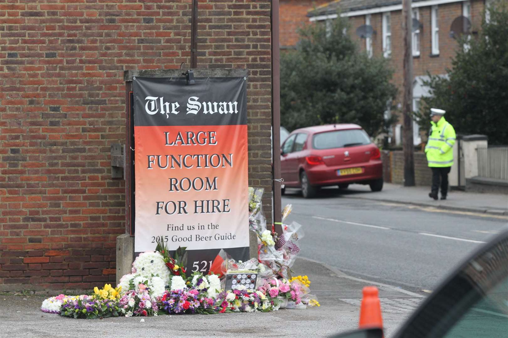 People laid flowers outside The Swan pub by the scene where a cyclist was involved in a fatal traffic accident with a lorry on the London Road in Teynham in 2016.